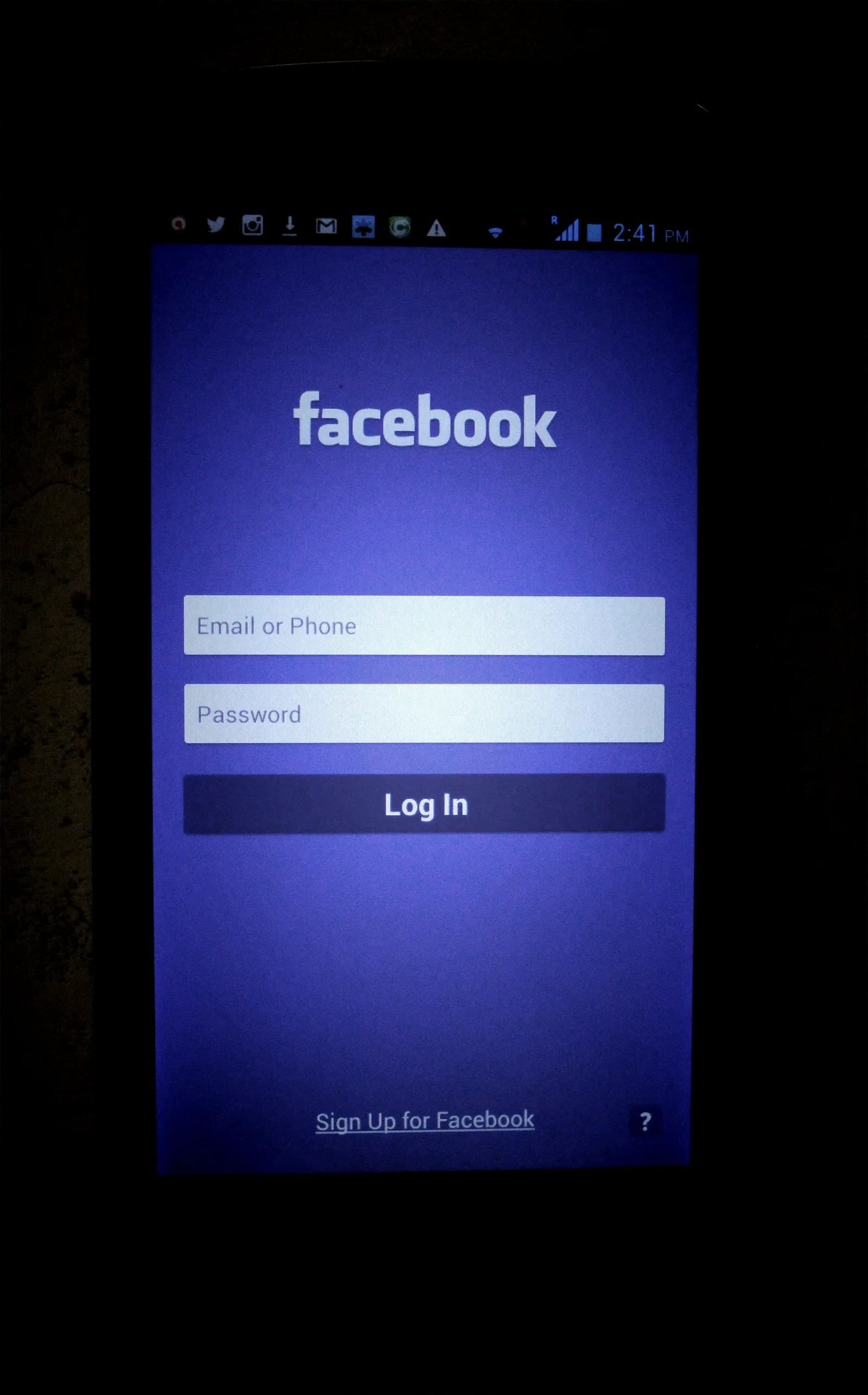 A phone showing a one-time authentication code next to a laptop, the setup attackers try to work around rather than break.