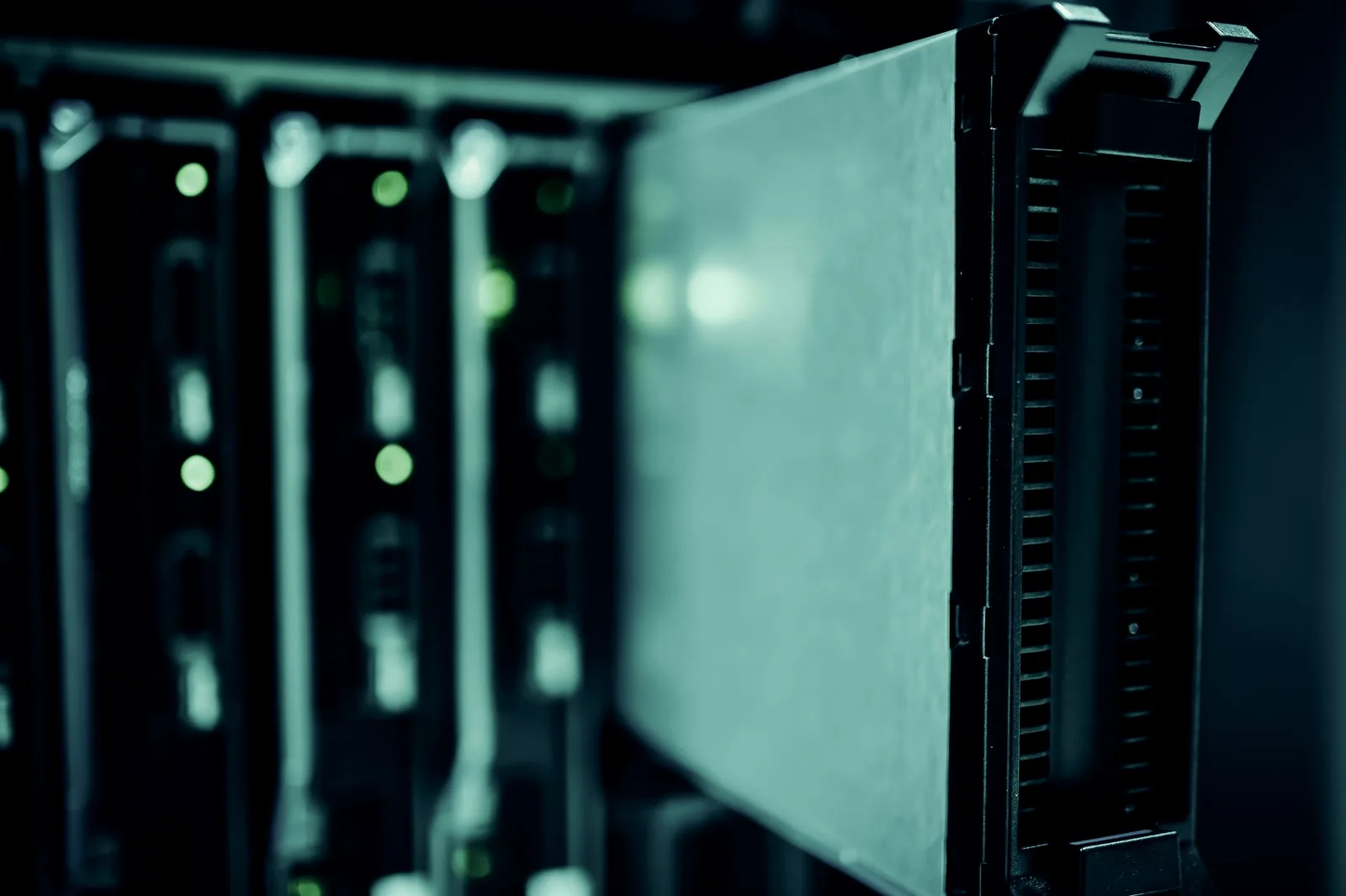 Rows of illuminated server racks in a data center, the corporate identity infrastructure credential monitoring protects.
