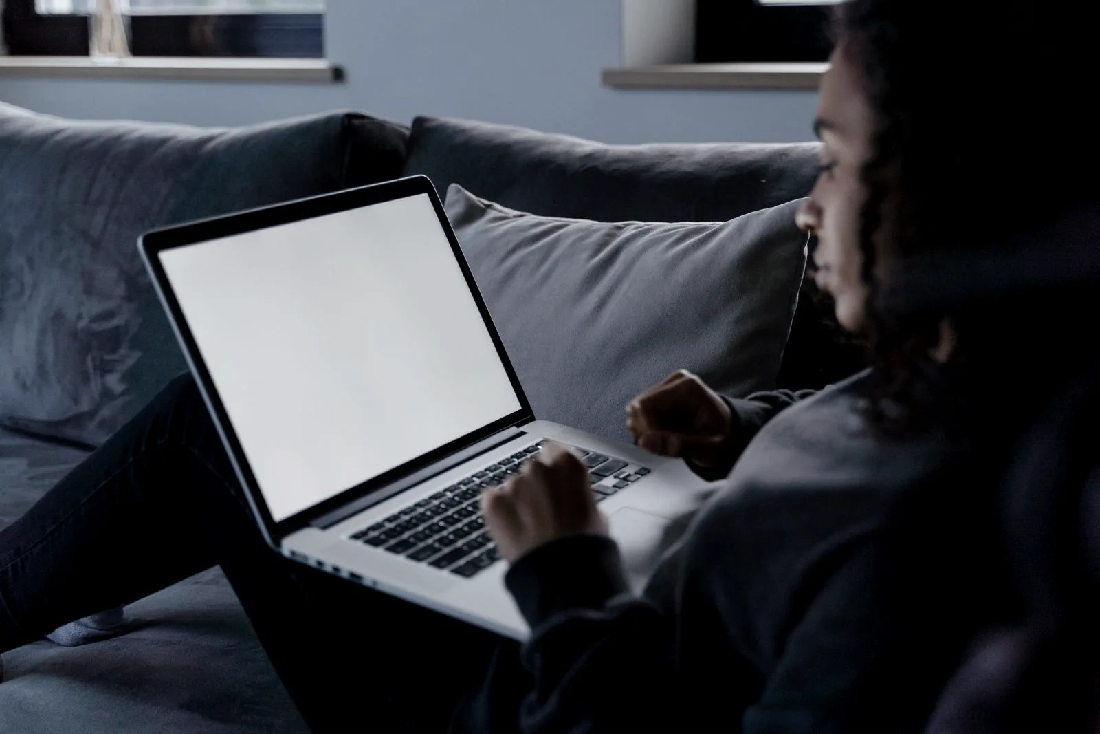 A laptop on a desk showing a website search field, the moment someone checks whether their email turned up in a data breach.